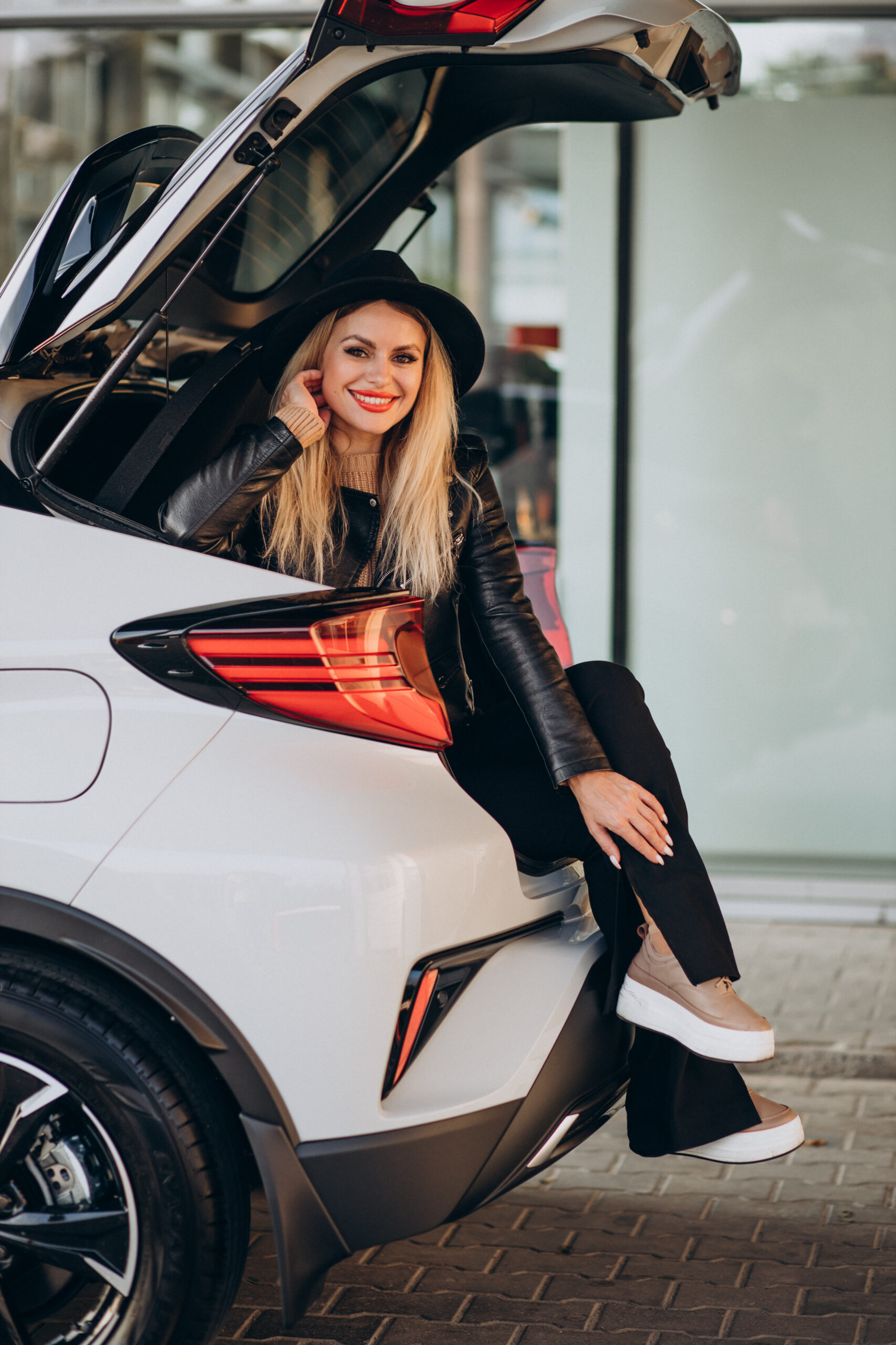 woman sitting in trunk of her car